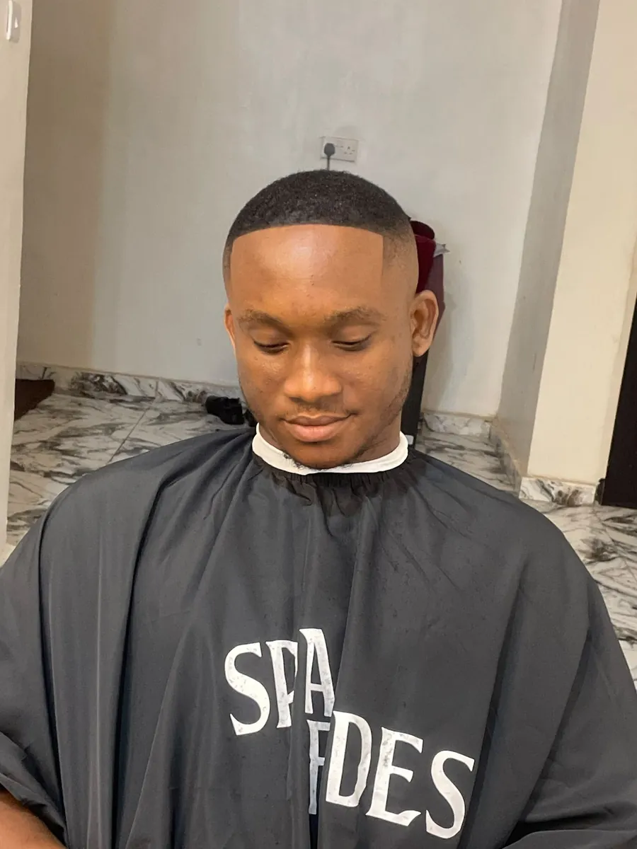Client with a bright, confident finish after a clean haircut by SPA_Fades